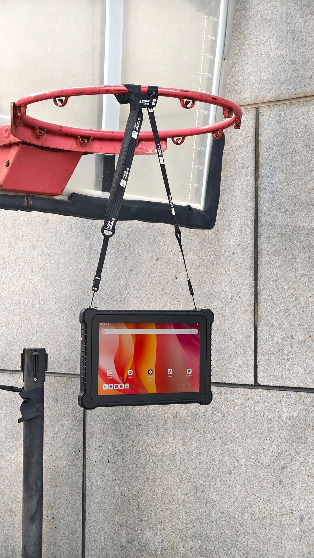 A worker in a high-visibility vest checking a heavy trailer with a rugged tablet A worker in a high-visibility vest checking a heavy trailer with a rugged tablet